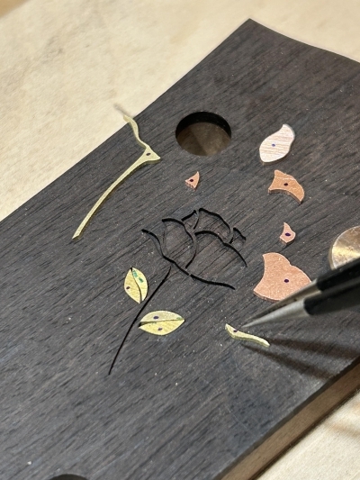 Rose peghead inlay, in process (copper/brass)